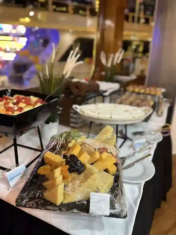 Joyful passengers eating and celebrating on a dhow cruise